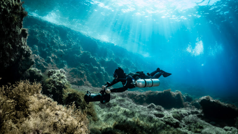 A sidemount diver using DPV in Gozo. DPV course in Gozo (Malta) with Sidemount Society.